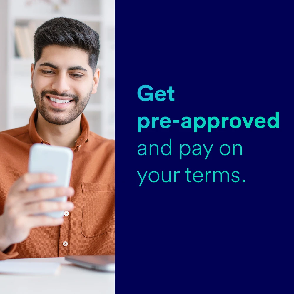 A man checking his financing pre-approval on his phone — get pre-approved and pay on your terms