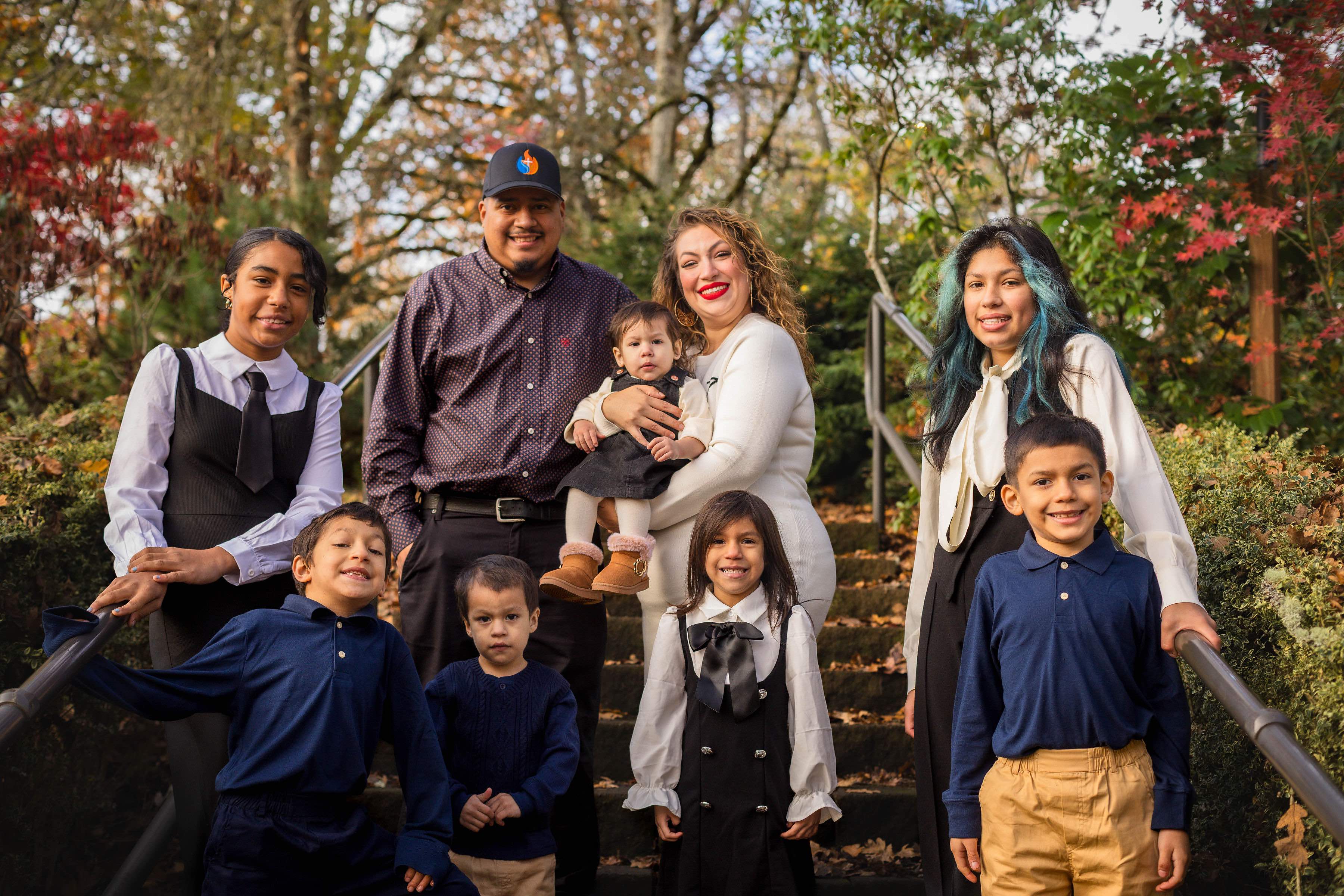 The family that owns and operates HVAC Ministries, photographed outdoors among fall foliage